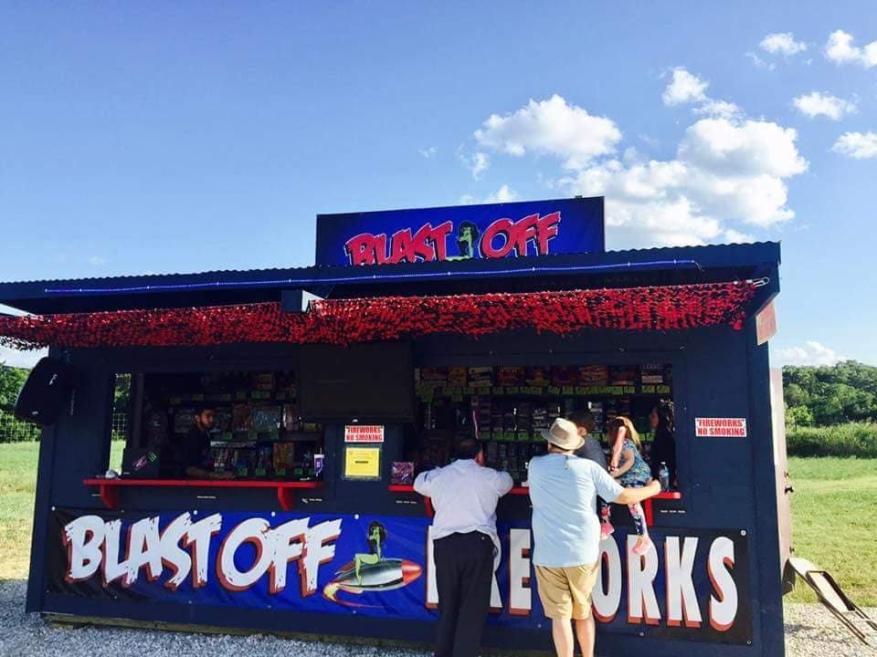 Fireworks stand with customers in summer.
