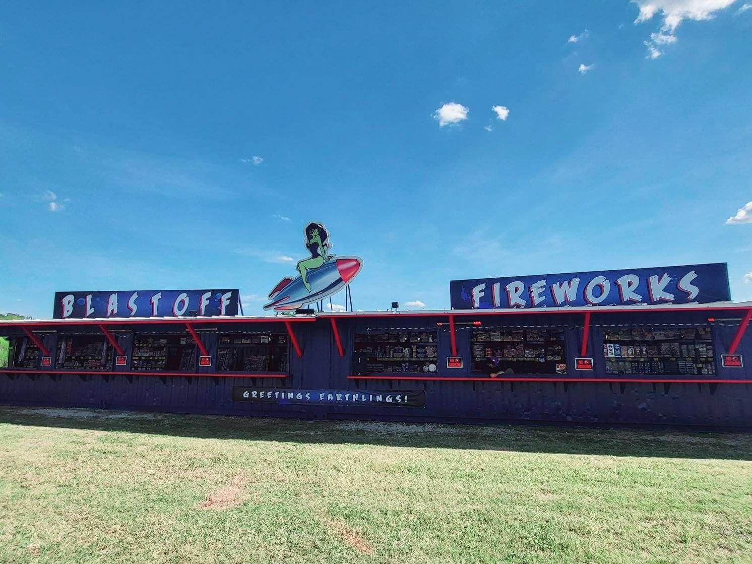 Fireworks stand with colorful rocket decoration.